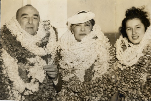 Samuel Wilder King, his wife and a young woman wearing many leis (ddr-njpa-2-557)