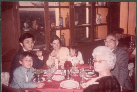 Agnes and Chester Sakura and family around restaurant table (ddr-densho-523-588)