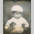Baby in white beret being held by unidentified person (ddr-densho-483-603)