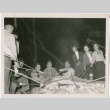 Roasting sausages on a campfire (ddr-densho-329-836)