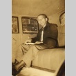 A man seated in backseat of a car (ddr-njpa-4-131)