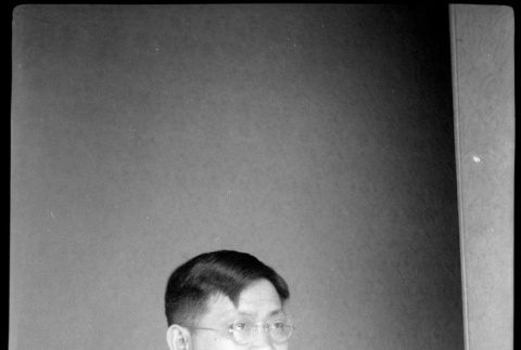 Portrait of man sitting at a table (ddr-densho-426-2004)