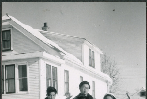 Sakura family standing in snow outside house, with cat (ddr-densho-523-237)