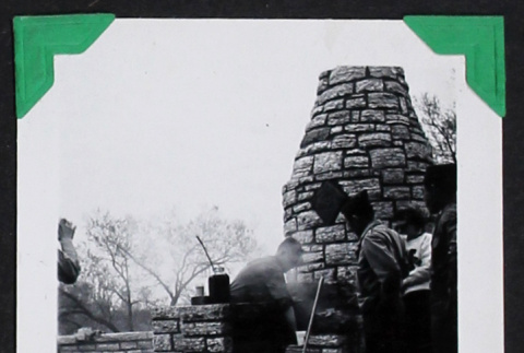 Men stand around a stone oven (ddr-densho-404-195)