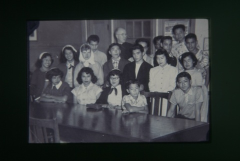 (Slide) - Image of group of young men and women around table (ddr-densho-330-173-master-307d104ab4)