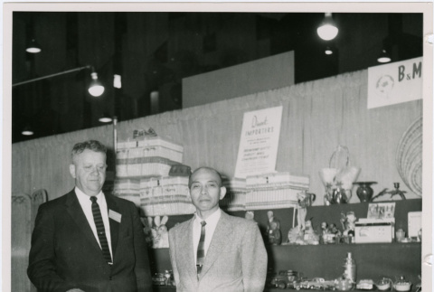 Two men pose at a booth (ddr-densho-359-1203)