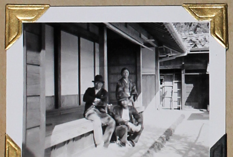 Two men and a woman on a porch (ddr-densho-404-295)