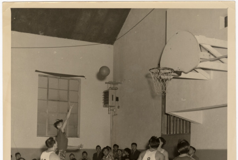 Photo of group of men playing basketball (ddr-densho-383-495)