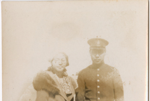 Tomoye (Nozawa) Takahashi standing with man in uniform (ddr-densho-426-1580)
