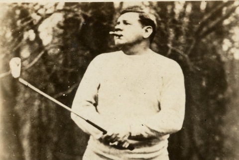Babe Ruth playing golf and smoking a cigar (ddr-njpa-1-1377)