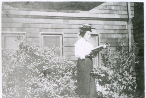 Woman reading outside (ddr-densho-1007-798)