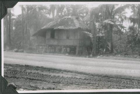 Building with thatch roof by road (ddr-ajah-2-651)