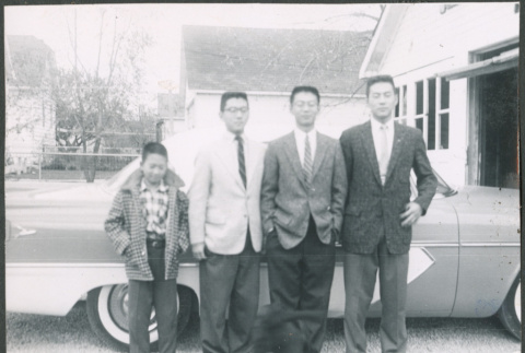 Sakura brothers standing next to car (ddr-densho-523-291)