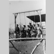 [Group photograph at swing set in Children's Village] (ddr-csujad-29-342)