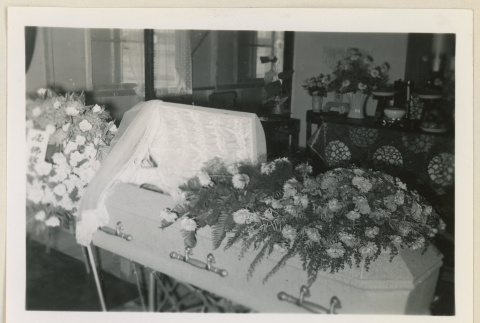 Flowers drape Sangoro Mii's casket (ddr-densho-37-933)