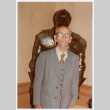 Man posing in front of suit of armor (ddr-densho-501-57)