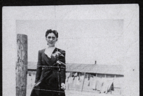 Woman behind barbed wire at Amache (ddr-densho-545-57)