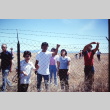 Pilgrims examining a barbed wire fence at Tule Lake (ddr-densho-294-54)