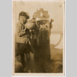 Girl standing next to machine on boat (ddr-densho-423-558)