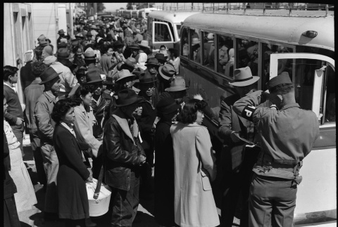 Japanese Americans boarding buses (ddr-densho-151-143)