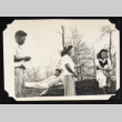 Four adults by a fallen tree (ddr-densho-542-727)