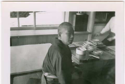 Man seated by low tables (ddr-densho-426-2461)