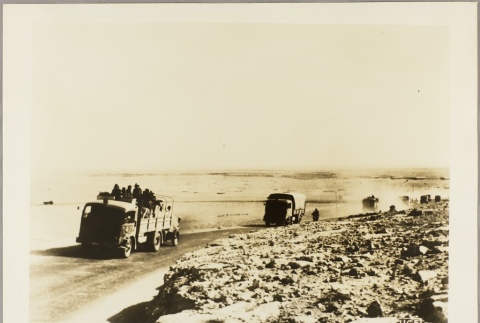 Italian soldiers riding in trucks on a dirt road (ddr-njpa-13-663)