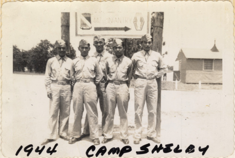 Group of five men standing by sign (ddr-densho-466-342)