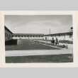 Two men pose with landscaping (ddr-densho-37-1040)