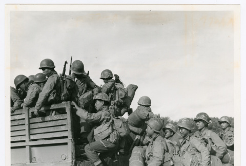 Japanese-American members of the 442nd climb into truck (ddr-densho-1007-146)
