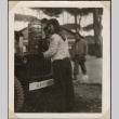 Woman serving coffee from army jeep (ddr-densho-466-2)