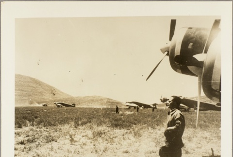 Italian pilot standing in front of a plane (ddr-njpa-13-779)