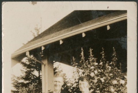 Couple by flowers outside house (ddr-densho-316-169)