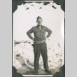 Man in uniform standing by pile of snow (ddr-ajah-2-275)