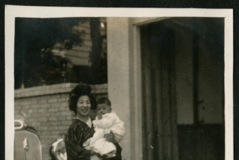 Woman and baby in front of car (ddr-densho-359-864)