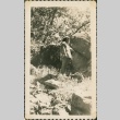 Woman stands near large rocks (ddr-densho-321-283)