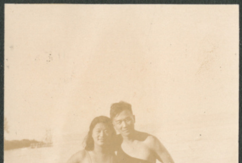Man and woman in swimwear standing on shore (ddr-densho-523-24)
