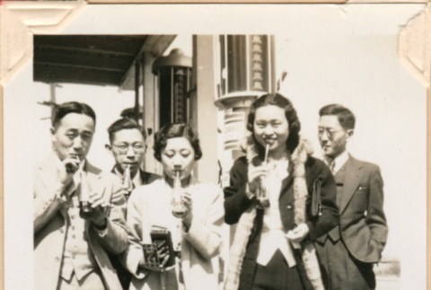 Photo of group drinking sodas outside a gas station (ddr-densho-341-79)