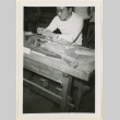Man working on a model ship (ddr-densho-37-1243)
