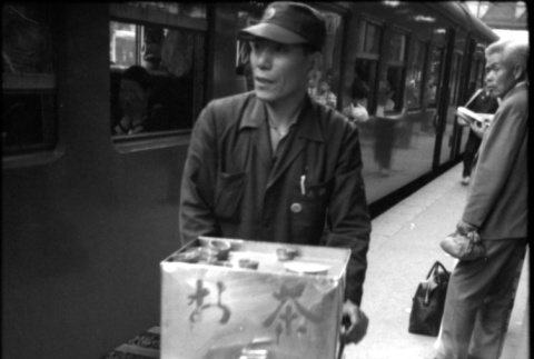 Street vendor outside train (ddr-densho-426-2302)