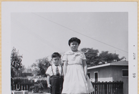 Girl and boy standing in yard (ddr-densho-522-491)
