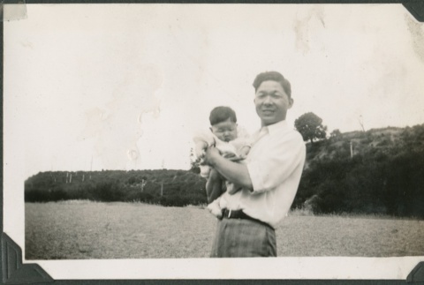 A man holding a baby (ddr-densho-321-716)