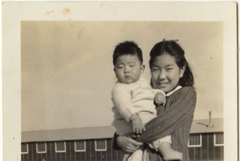 Itoko Sano holding Lloyd Takasugi in Rohwer concentration camp (ddr-densho-331-9)