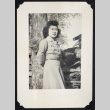 Nori poses next to firewood (ddr-densho-542-701)