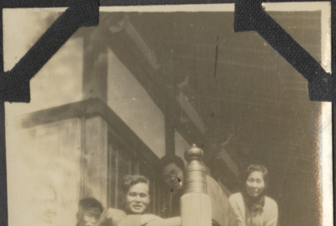 A group sitting on a deck (ddr-densho-432-135)