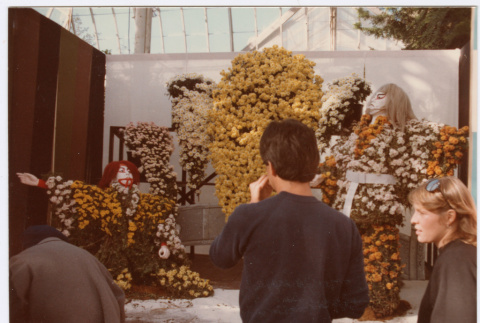 Man standing by flower display (ddr-densho-329-1201)