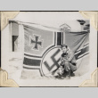 Man kneeling by Nazi flag (ddr-densho-466-736)