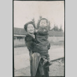 Woman holding toddler, likely Jon David Sakura (ddr-densho-523-72)