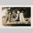 Tomoye (Nozawa) Takahashi and unidentified woman sitting in park (ddr-densho-426-2104)