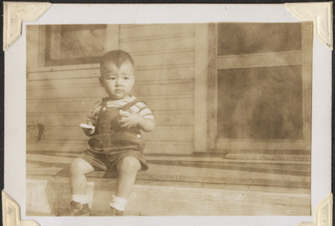 Small boy sitting on steps (ddr-densho-466-883)